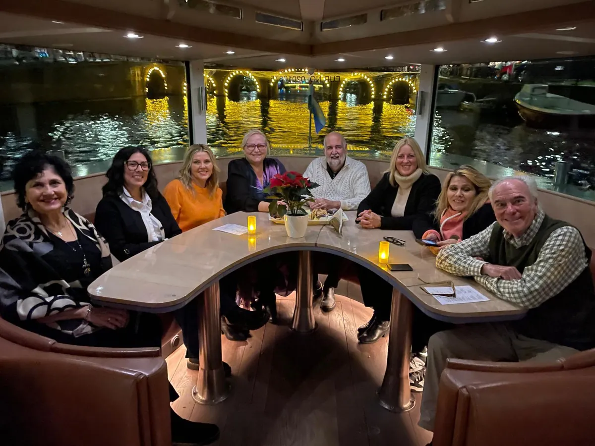 Melissa-with-a-group-of-our-fellow-agents-enjoying-an-evening-cruise-on-a-canal-in-Amsterdam